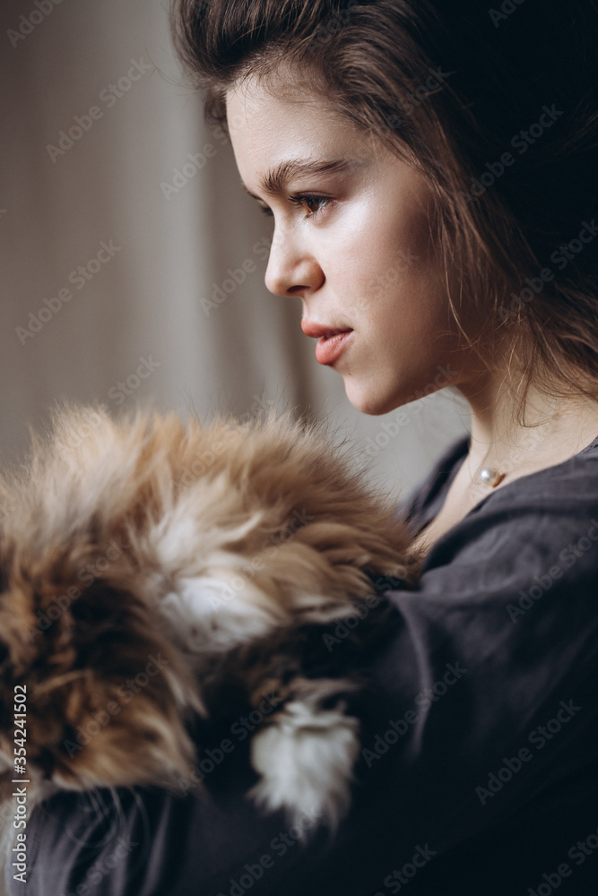 Girl communicates with her domestic red fluffy cat. Love for animals. Girl communicates with her domestic red fluffy cat. Love for animals.