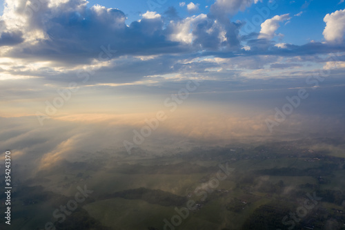 Summer nature landscape aerial panorama with sunrise. Morning fog and sunrise  meadow and forest and field.