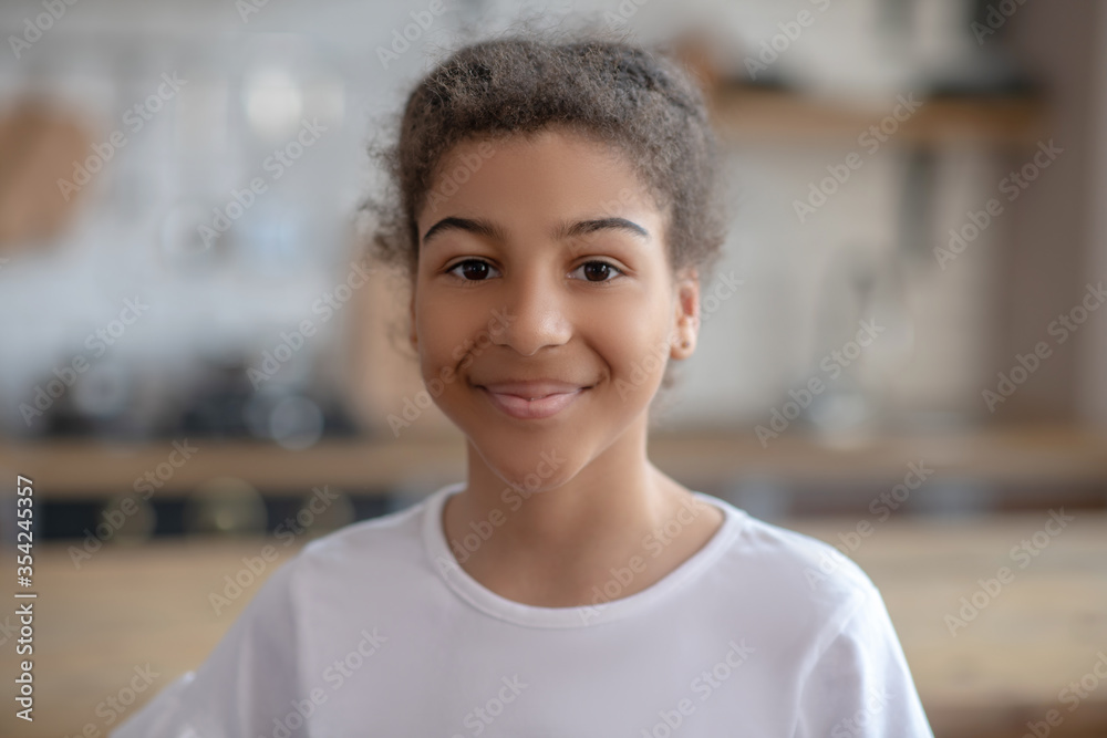 Cute curly-haired girl smiling and feeling happy Cute curly-haired girl smiling and feeling happy