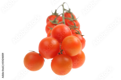 bunch of round red tomatoes on a white background