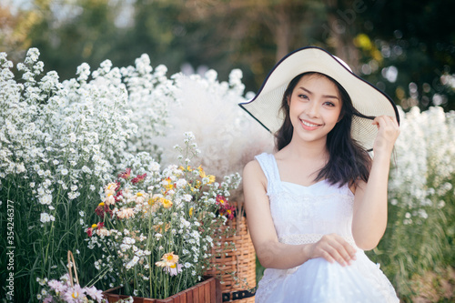 outdoor portrait of a beautiful asia woman. attractive cute girl in a field with flowers