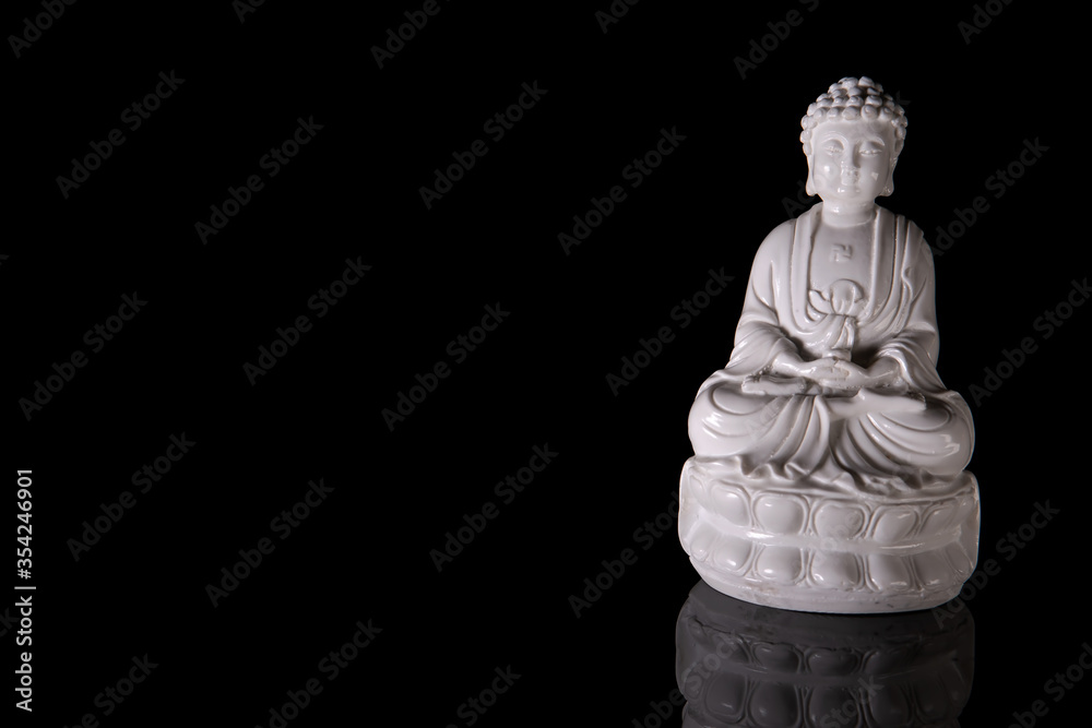Fototapeta premium White Buddha on a black background with reflection