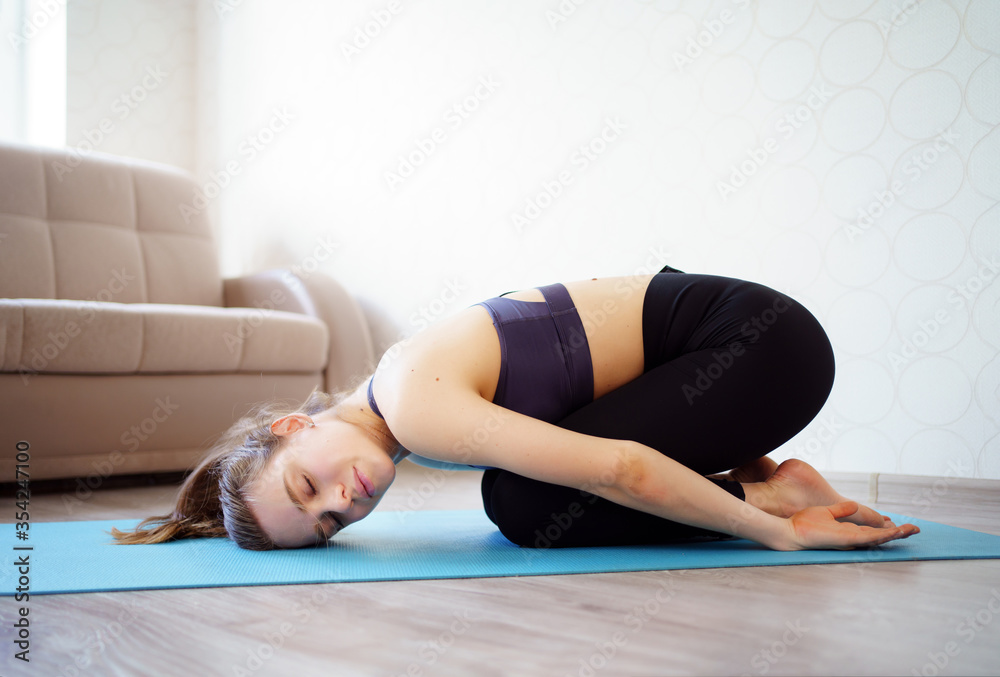 yoga. beautiful girl is engaged in sports at home, making stretching. online workout. yoga. beautiful girl is engaged in sports at home, making stretching. online workout.