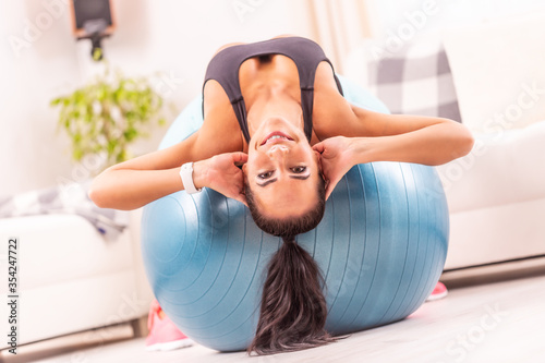 Fotografía Girl lying upside down on a swiss ball at home