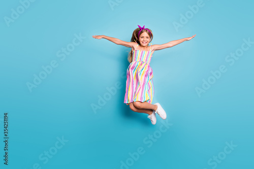 Full length body size view of her she nice-looking attractive lovely free cheerful cheery girl jumping having fun vacation holiday isolated over bright vivid shine vibrant blue color background