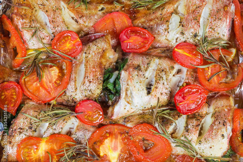 Background of the baked red perch with tomatoes and rosemary