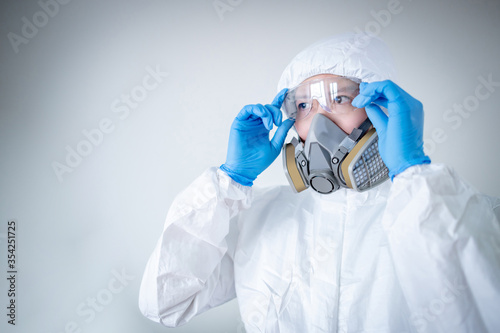 Scientist or Virologist man wearing biohazard chemical protective suit, goggles and mask. Male doctor or medical worker wearing PPE and rubber gloves for preventing Coronavirus (COVID-19) infection.