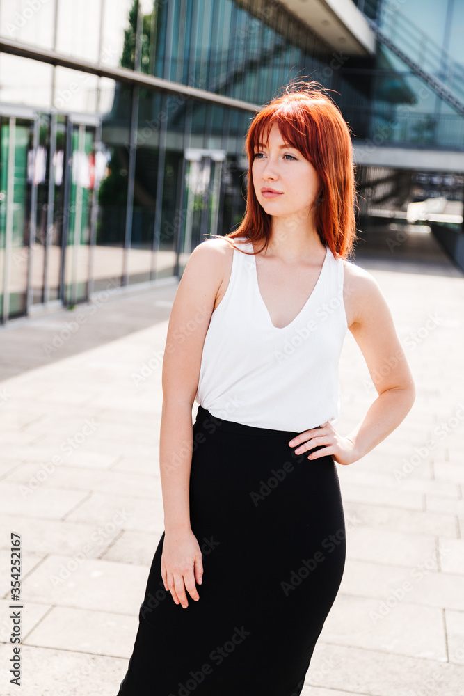 Young redhead business woman in formal outside