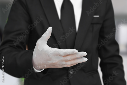 Close up of businessman wearing white latex gloves. Concept for protection health care from corona virus or covid-19 at work.