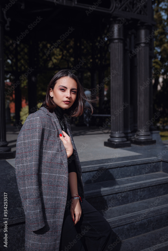 Fototapeta premium Beautiful young brunette woman walks in Moscow.