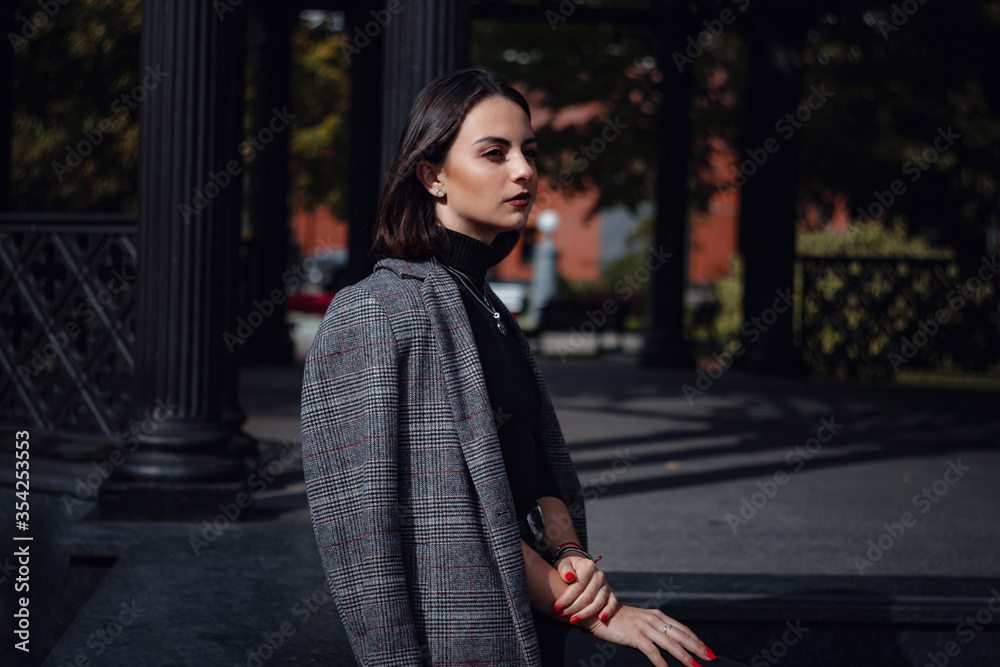 Fototapeta premium Beautiful young brunette woman walks in Moscow.