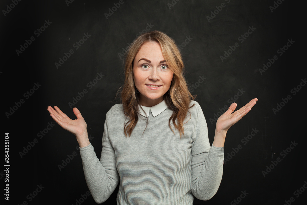 Happy woman with empty open hand on black background Happy woman with empty open hand on black background