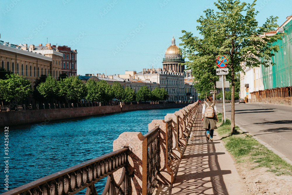 Fontanka river embankment in Saint Petersburg, the dome of St. Isaac's Cathedral on a Sunny day