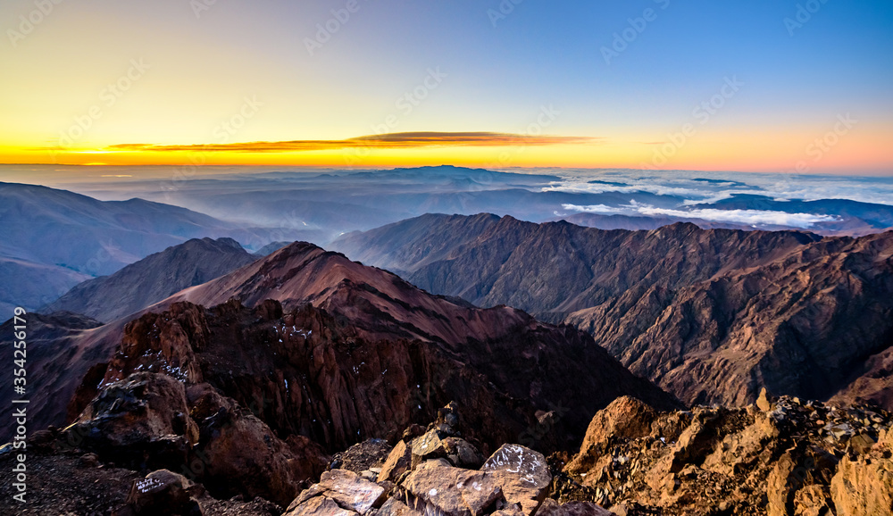 On the summit of Jebel Toubkal, highest mountain in Morocco during sunrise.