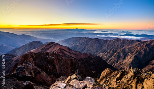 On the summit of Jebel Toubkal, highest mountain in Morocco during sunrise. photo
