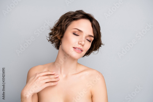 Portrait of positive pretty charming lovely girl enjoy her ideal fresh perfect skin after rejuvenation spa salon peeling procedure touch body hand isolated over gray color background
