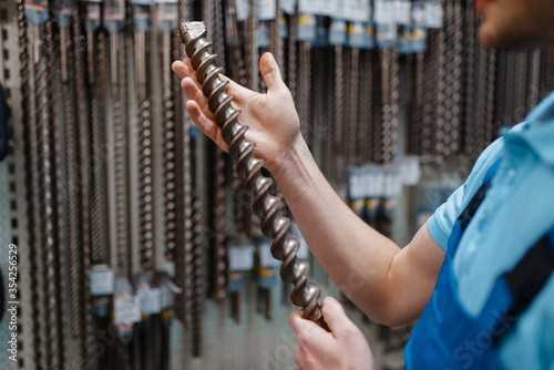 Employee choosing concrete drill in tool store