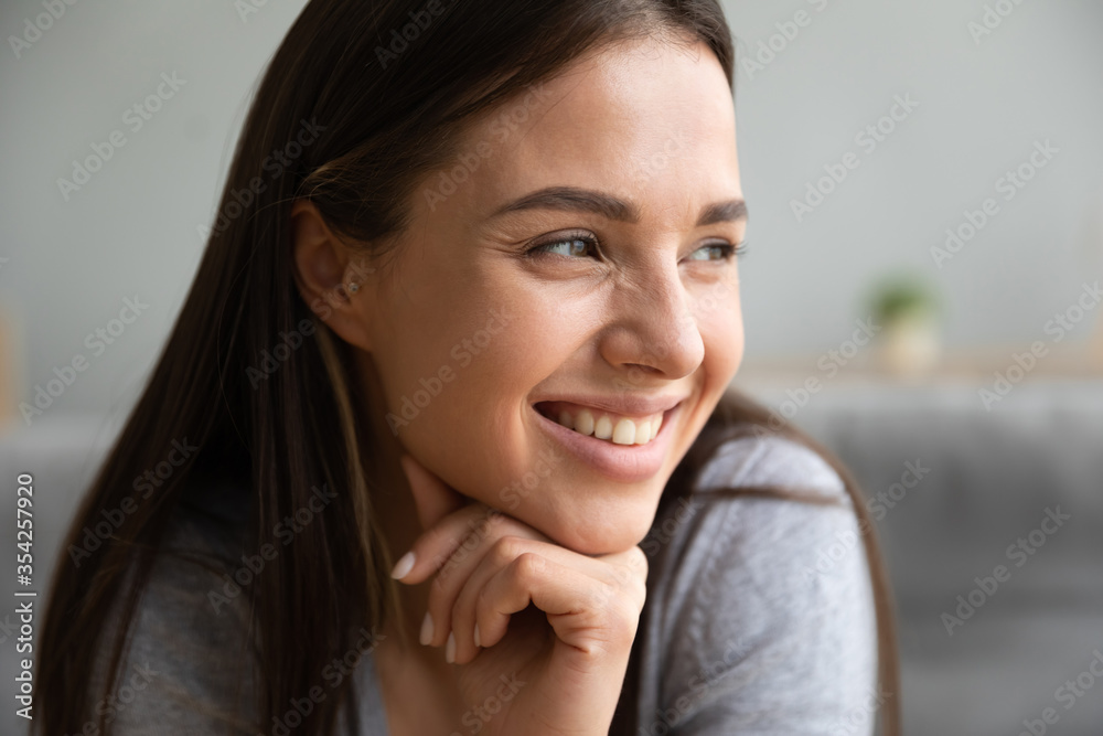 Close up view smiling positive young woman face, girl seated comfortable looking away daydreams enjoy view through window, female having white straight teeth dental service satisfied client ad concept Close up view smiling positive young woman face, girl seated comfortable looking away daydreams enjoy view through window, female having white straight teeth dental service satisfied client ad concept