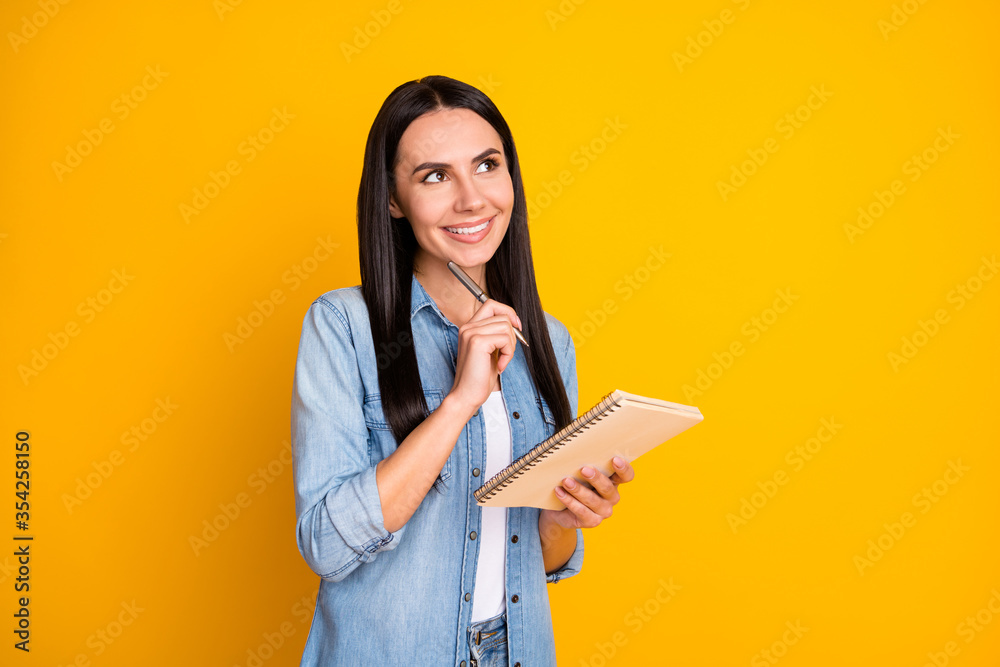 Portrait of minded interested girl author hold note book want write story think thoughts look copyspace pen touch chin wear trendy stylish outfit isolated over bright color background Portrait of minded interested girl author hold note book want write story think thoughts look copyspace pen touch chin wear trendy stylish outfit isolated over bright color background