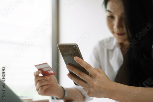 Shopping online with smartphone and credit card on hand