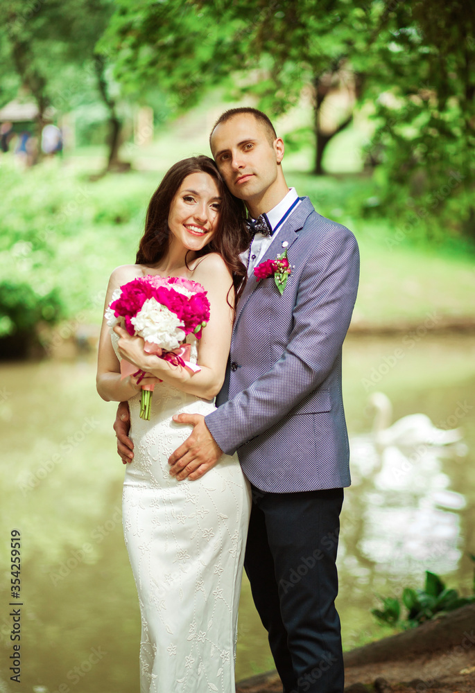 Pretty couple on a lake background on their wedding day