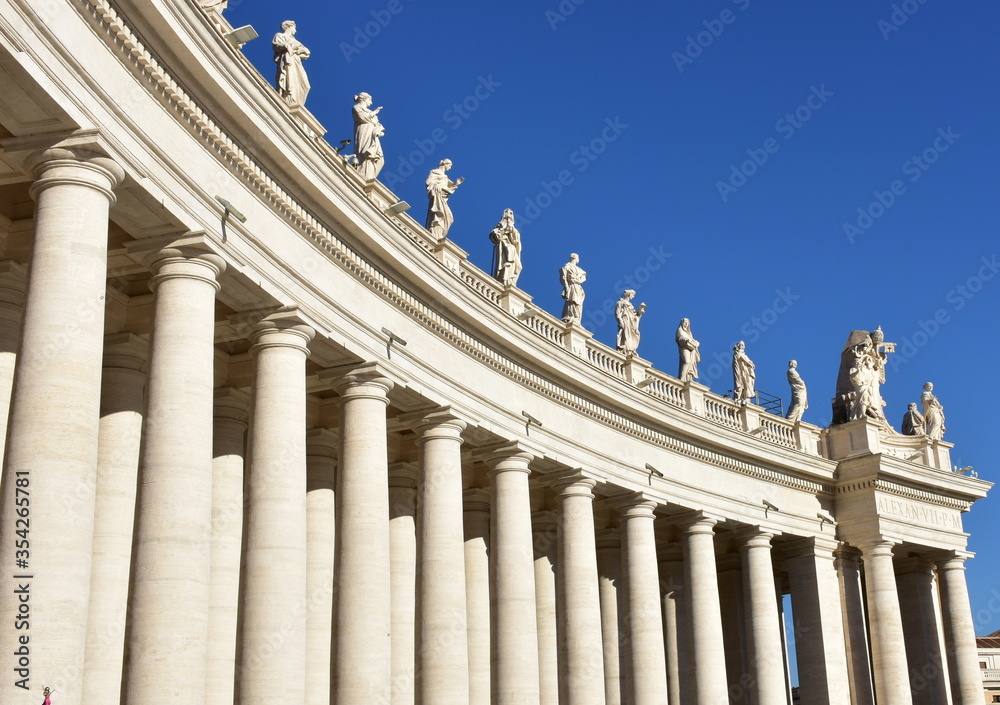 Bernini’s Colonnade and statues at St. Peter’s Square with blue sky. Vatican City, Rome, Italy. Bernini’s Colonnade and statues at St. Peter’s Square with blue sky. Vatican City, Rome, Italy.