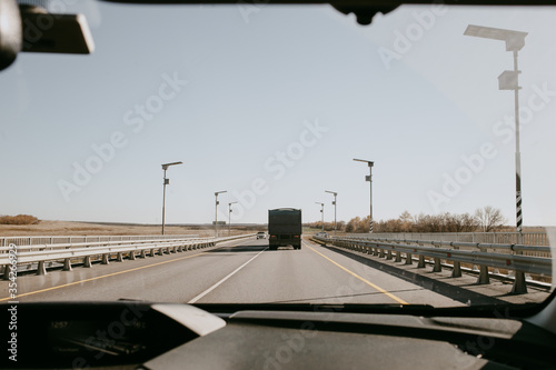 view through the windshield of a car on a summer day photo