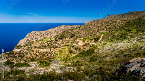 view over the old terraces and ruins of la trapa monastery nearby sant elm in springtime on mallorca, hiking route gr221 ruta de piedra en seco photo