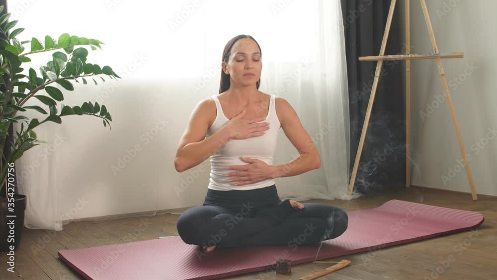 Young woman sit with crossed legs and relax with incense sticks. Yoga, healthy lifestyle concept. Young woman sit with crossed legs and relax with incense sticks. Yoga, healthy lifestyle concept.