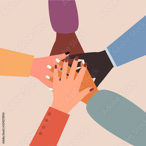 Top view of hands. Hands of diverse group of people putting together. Concept of cooperation, unity, togetherness, partnership, agreement, teamwork, social community or movement.