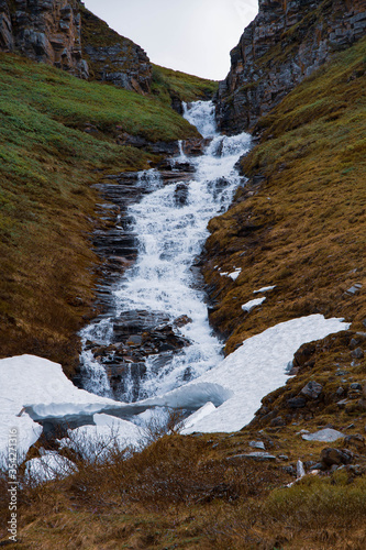 Cascade falls over mossy rocks