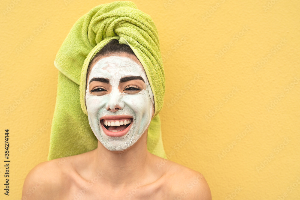 Happy girl applying facial mask portrait - Young woman having skin care spa day - Beauty clean treatment day and cosmetology products concept Happy girl applying facial mask portrait - Young woman having skin care spa day - Beauty clean treatment day and cosmetology products concept