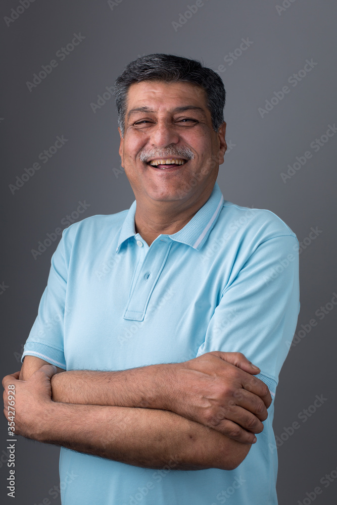 Studio portrait of a confident mature man posing against a gray background. Studio portrait of a confident mature man posing against a gray background.