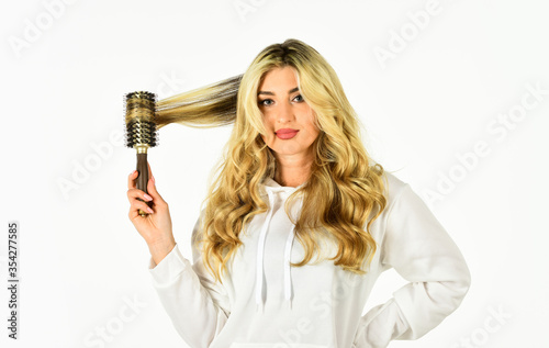 Curling Your Hair Much Easier. Hot curling brush. Pretty woman brushing hair isolated on white background. Long hair. Hair care. Hairdresser salon. Professional equipment. Beauty supplies shop