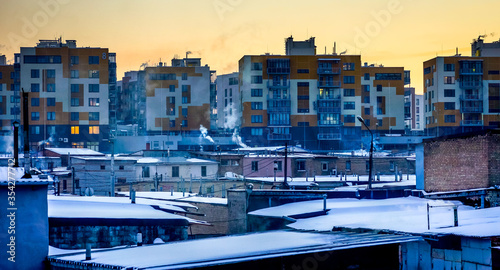 evening under winter city with many multi storey houses