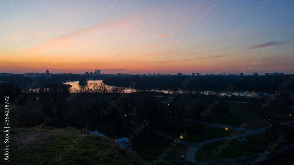 View of the confluence of the Sava and Danube rivers from the Kalemegdan Fortress in Belgrade, at dusk. View of the confluence of the Sava and Danube rivers from the Kalemegdan Fortress in Belgrade, at dusk.
