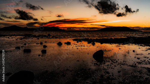 Icredible sunset on paradise island, high contrast and twisting clouds.