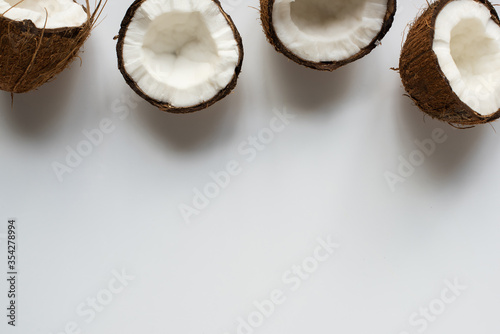 top view of fresh tasty coconut halves on white background with copy space