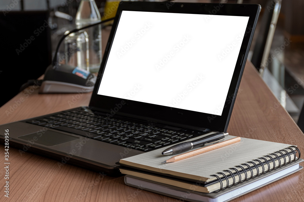 Laptop with a pen and notebook on the table in meeting room Laptop with a pen and notebook on the table in meeting room