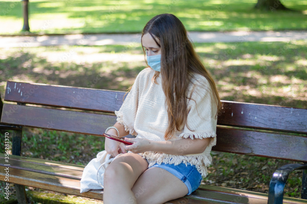 girl sitting on the street with face mask girl sitting on the street with face mask