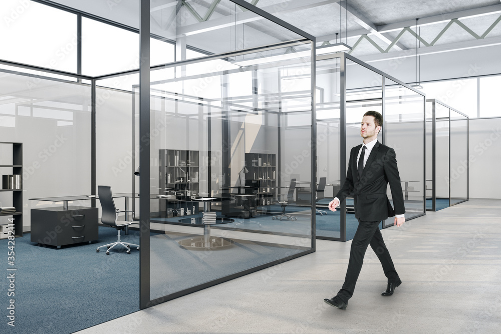 Businessman walking in glass boardroom