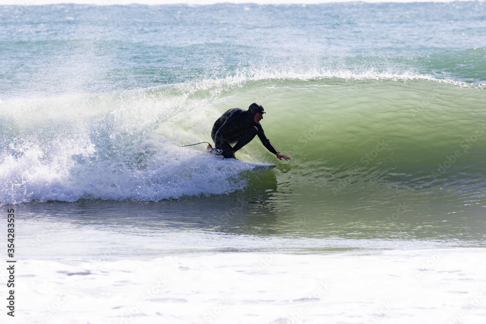 Japan surfing , sometimes during a typhoon, there are many waves in Japan especially in Hebara, Katsuura, Chiba. Westerner surfs large waves. Sunrise & at the beach with a surfer & his surf board. Japan surfing , sometimes during a typhoon, there are many waves in Japan especially in Hebara, Katsuura, Chiba. Westerner surfs large waves. Sunrise & at the beach with a surfer & his surf board.
