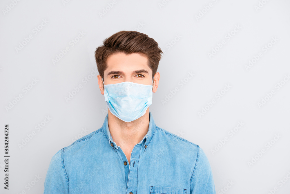 Portrait of handsome young successful businessman in blue shirt wear medical safety mask on face, pandemic virus prevention protection concept Portrait of handsome young successful businessman in blue shirt wear medical safety mask on face, pandemic virus prevention protection concept