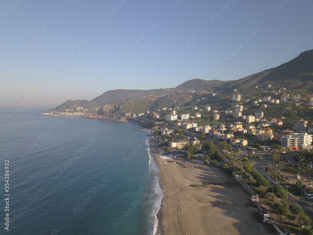view of the coast of the mediterranean sea, view of the beach, waves on the beach, turkey, alanya, Mediterranean sea, travel around turkey, mountains