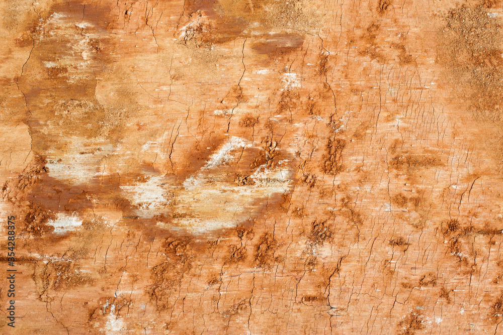Naklejka premium Clay soil background, orange soil, closeup, texture
