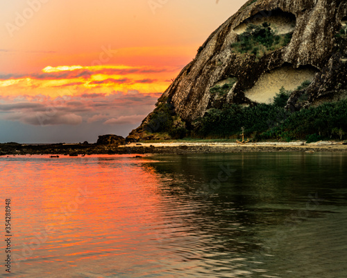 sunset over the sea by the angry rock
