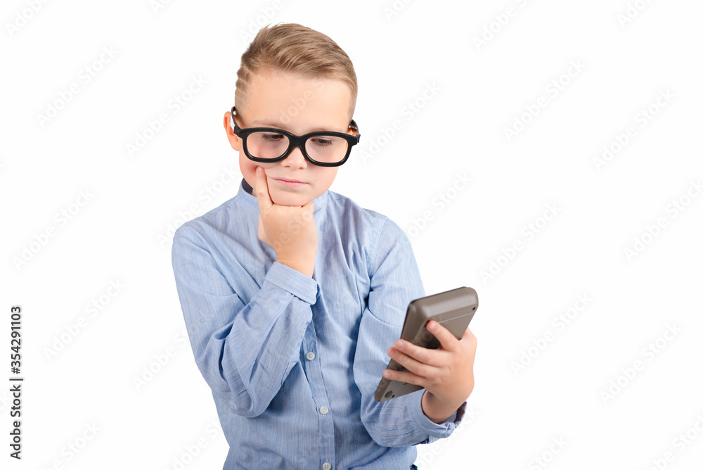 Surprised student holding calculator. Portrait of funny cute teen boy touching his head with hand. Shocked child with calculator looking at camera.White background. Surprised student holding calculator. Portrait of funny cute teen boy touching his head with hand. Shocked child with calculator looking at camera.White background.