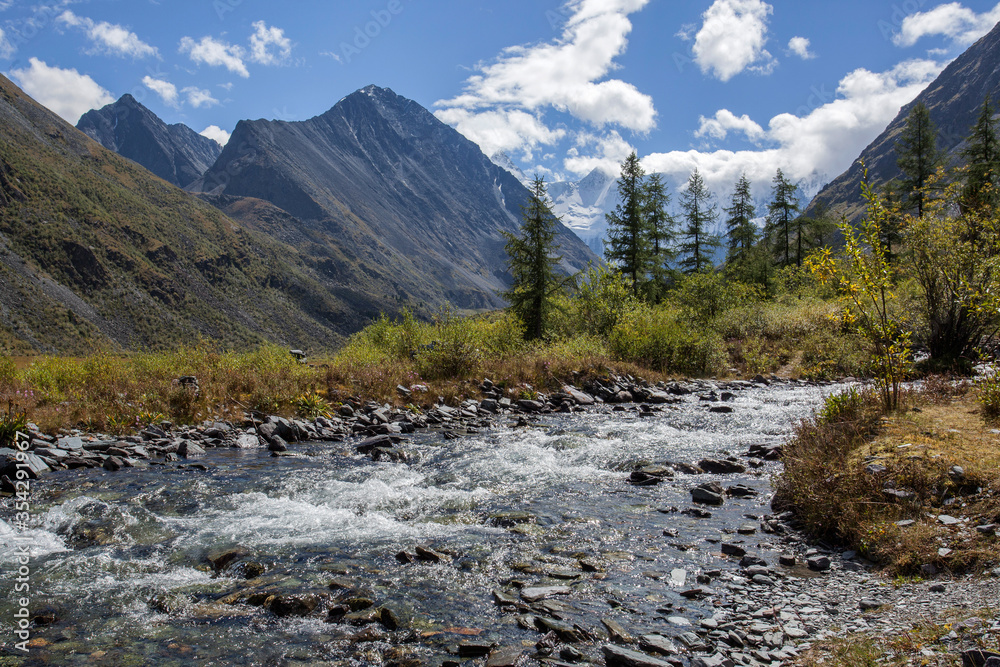 Mountain stream against the backdrop of Belukha Mountain in the Altai Republic.