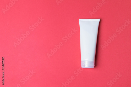 Wallpaper Mural tube with cream on red colored paper background with copy space Torontodigital.ca