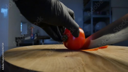 closeup of cutting tomatoes for pizza at restaurant kitchen